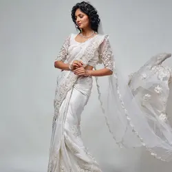 Wedding saree is highlighted with pearls and cut work